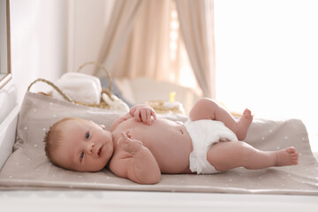 Wall Mural - Cute little baby on changing table in room