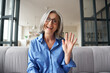 © insta_photos - Happy mature middle aged woman online teacher waving hand talking to web cam video conference calling in virtual webcamera chat meeting by distance remote vidoecall. Headshot portrait. Webcam view.