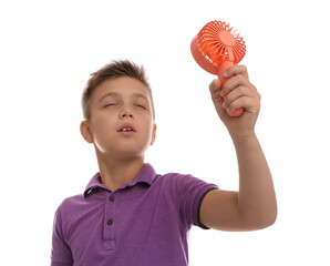 Wall Mural - Little boy enjoying air flow from portable fan on white background. Summer heat