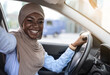 © Prostock-studio - Car Selfie. Cheerful black muslim woman taking self-portrait in her new auto