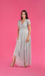 © New Africa - Young woman wearing stylish dress on pink background