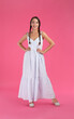 © New Africa - Young woman wearing stylish dress on pink background