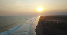 Beautiful Cinematic, Drone Aerial Flying High Over The Shore Of A Beach With Black Sand During Sunset, Monterrico Guatemala.