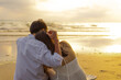 © Charnchai saeheng - Couple in love watching sunset together on the beach travel summer holidays. People romance concept.
