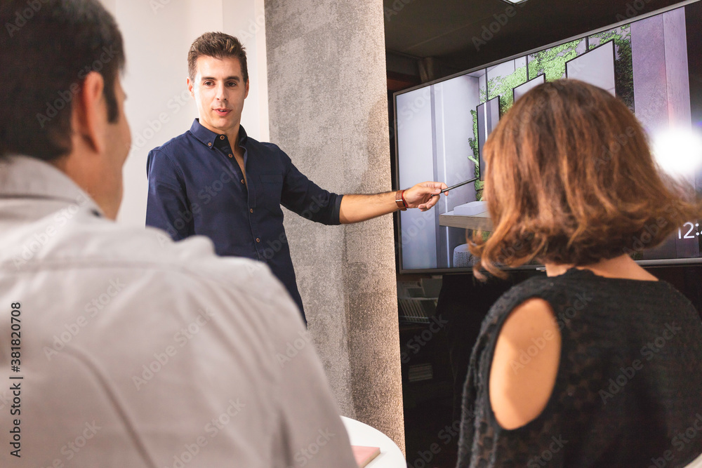 Design Talk Photo Stock Three young architects discussing together inside a ...