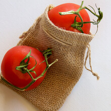 Two Ripe Truss Tomatoes In A Brown Hessian Bag. 