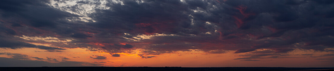 Purple-magenta clouds. Tragic gloomy sky. Landscape with bloody sunset. Fantastic skies on the planet earth. Twilight, nightfall.