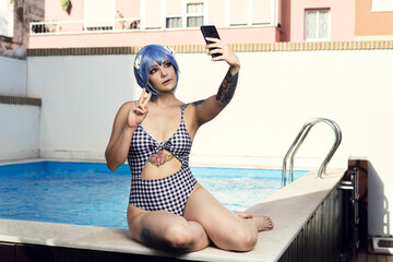 Sticker - European female with blue hair taking a selfie at a swimming pool