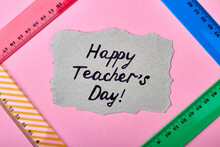 Colorful Design Of Happy Teacher's Day. Composition Of Colorful Rules And Piese Of Paper On Pink Background.
