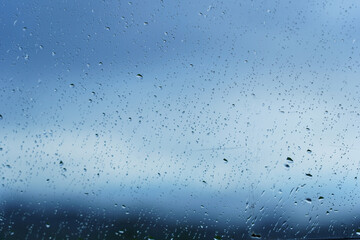 Rain drop on windscreen shot from in car during rainy day.