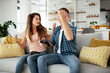 © JustLife - Husband and wife playing video game with joysticks in living room. Loving couple are playing video games at home