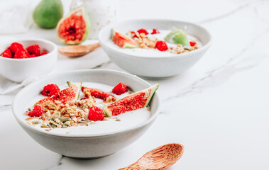 Poster - Granola with yogurt, figs and raspberries in bowls