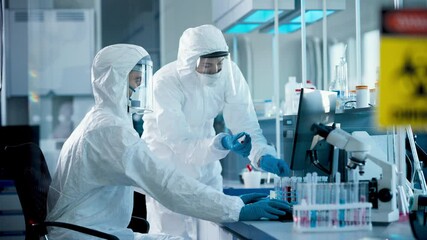 Wall Mural - medical laboratory: diverse team of microbiology scientists wearing sterile coveralls, face masks ta