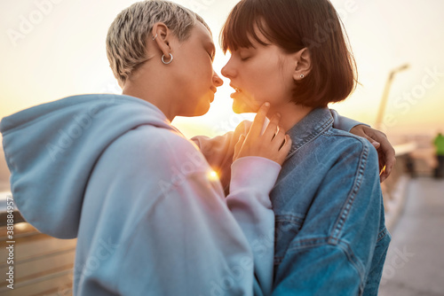 Fotografía Young lesbian couple having romantic moment, Two women going to kiss while watch