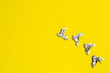 © dimakig - Flying origami doves on yellow background. Origami birds from music paper. Concept of festive music postcard.