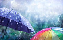 Abstract Weather Concept - Rain And Lightning On Umbrellas With Defocused Background 
