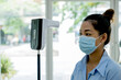 © Lucky7Trader - The Asian tourist woman has checked body temperature with a thermal Temperature scanner detector travel safety