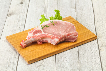 Raw pork bone steak over wooden