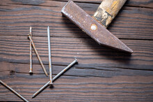 Old Vintage Hammer And Nails On A Wooden Background, Close-up, Selective Focus.