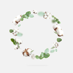 Wall Mural - Flying cotton flowers, green twigs of eucalyptus round frame on gray background. Creative Floral background with cotton, delicate flowers of fluffy cotton. Flat lay flowers composition, greeting card