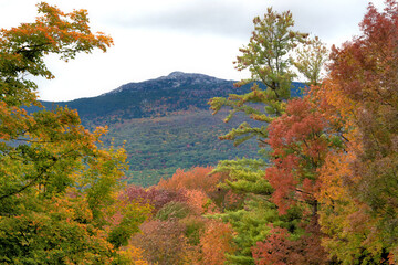 Rocky summit of Mount Monadnock (Grand Monadnock) framed by colorful autumn leaves - designated a National Natural Landmark in 1987.