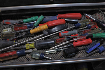 Drawer full of various screwdrivers