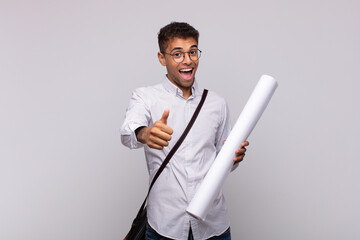 Wall Mural - young architect man feeling proud, carefree, confident and happy, smiling positively with thumbs up