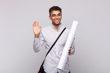 Wall Mural - young architect man smiling happily and cheerfully, waving hand, welcoming and greeting you, or saying goodbye