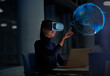 © Robert Daly/Caia Image - Businesswoman with virtual reality glasses touching virtual globe