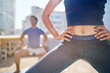 © Trevor Adeline/Caia Image - Close up young woman with belly piercing practicing yoga on balcony
