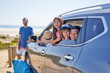© Trevor Adeline/Caia Image - Portrait happy family in car at sunny  beach
