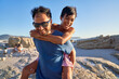 © Trevor Adeline/Caia Image - Happy father piggybacking son on sunny beach
