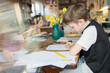 © Paul Bradbury/Caia Image - Boy doing homework at dining table