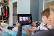 © Paul Bradbury/Caia Image - Family video chatting with digital tablet on bed
