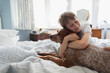 © Paul Bradbury/Caia Image - Cute boy hugging dog on bed