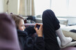 © Paul Bradbury/Caia Image - Boy playing video game with smart phone on sofa