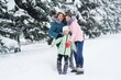 © Evgeniy Kalinovskiy - family-mother and two daughters have fun and play against the background of snow-covered trees and forests. Winter fun