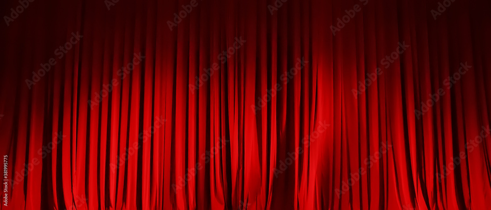 Closed red curtain of stage in spotlight before show. - obrazy, fototapety, plakaty 