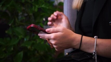 Poster - The woman uses a mobile phone in her hands. Presses a finger on the screen buttons. Viewing messages and letters in the messenger.