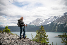 Serene Woman Hiking At Scenic Mountain Lakeside