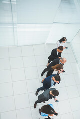 Wall Mural - top view. a group of business people looking at their smartphon screens.