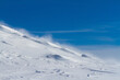 © tartalja - .Snowy mountain slope with wind, winter background