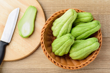 Chayote squash or Mirlition squash on wooden cutting board, organic vegetable, edible plant fruit