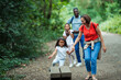 © Paul Bradbury/Caia Image - Happy family walking on trail in woods