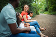 © Paul Bradbury/Caia Image - Happy family sitting on bench on path in park