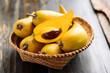 Eggfruit or canistel in a basket on wooden table, Thai fruit, In Thai names such as Xiantao, Lamut Khamen or Mon khai