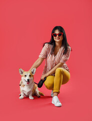 Sticker - Woman with cute corgi dog on color background