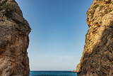 Fototapeta Desenie - Sunny day over the rocks and the blue water in Sa Calobra, Palma de Mallorca, Balearic Islands, Spain
