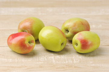 Wall Mural - whole apples on wooden background -