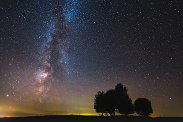 Wall Mural - Landscape with Milky way galaxy glowing in the night sky